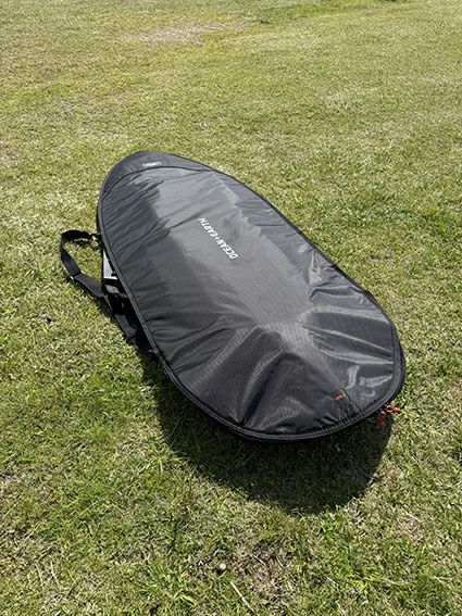 OCEAN&EARTHのボードバッグ　 COR_X FISH DAY COVER 5.4ftの中にボードを入れている様子